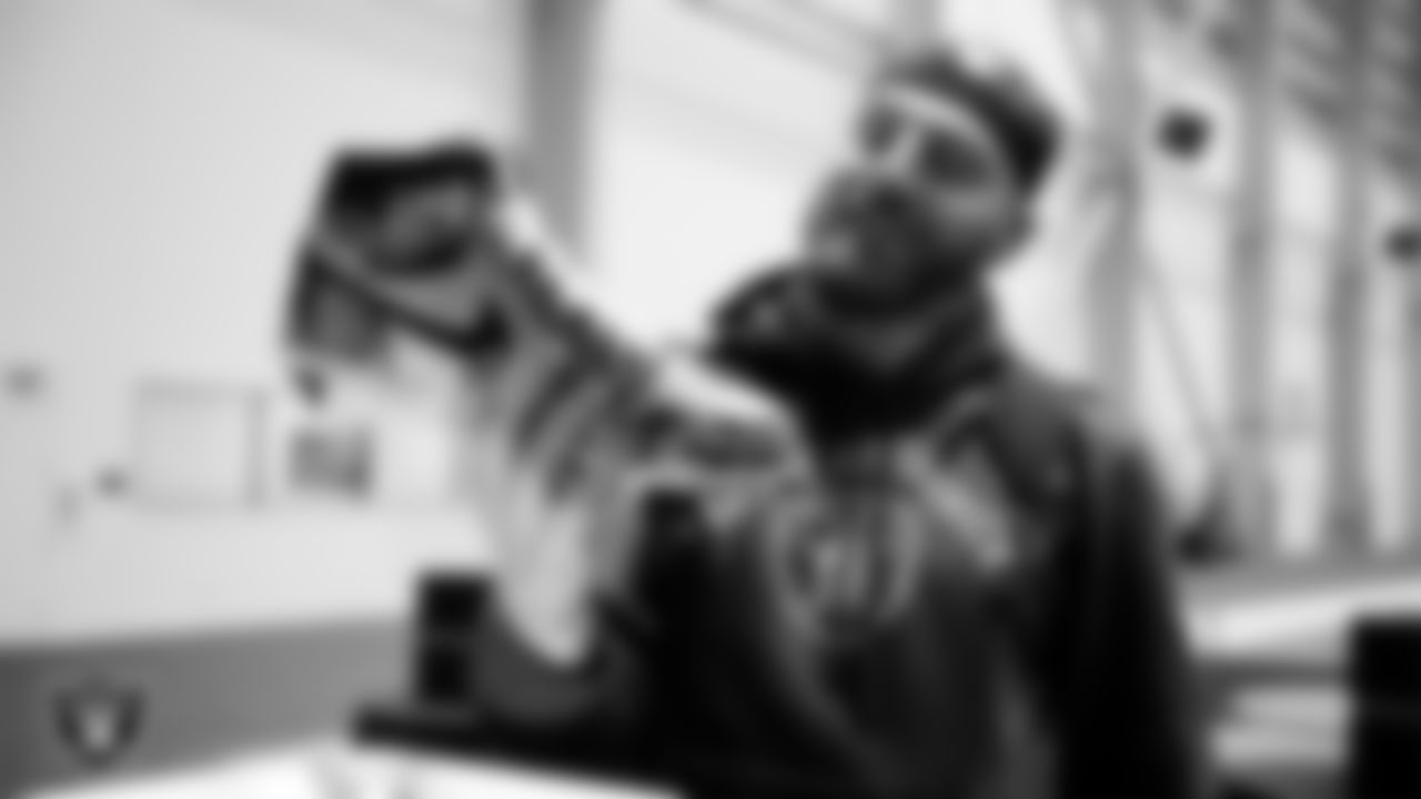 Las Vegas Raiders defensive end Maxx Crosby (98) unboxes his custom cleats for the NFL's My Cause My Cleats initiative at Intermountain Health Performance Center.