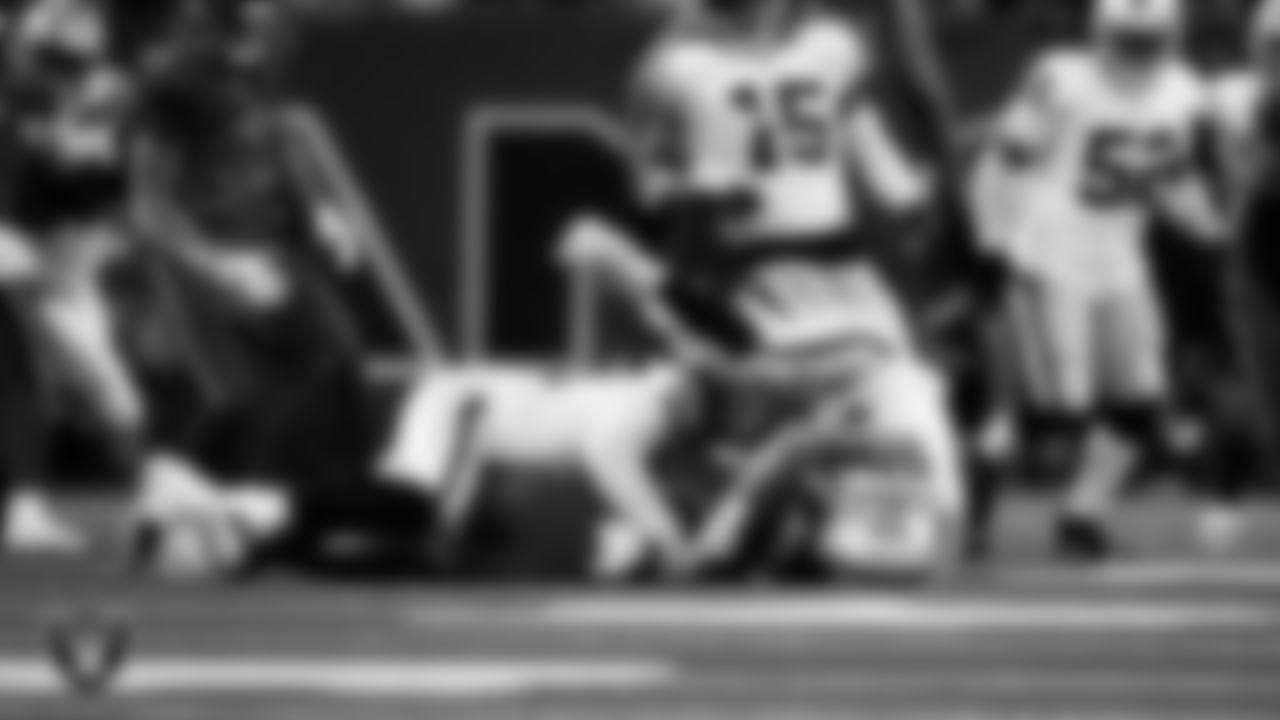 Las Vegas Raiders defensive tackle Tonka Hemingway (97) and defensive end Maxx Crosby (98) make a tackle during the regular season away game against the Houston Texans at NRG Stadium.