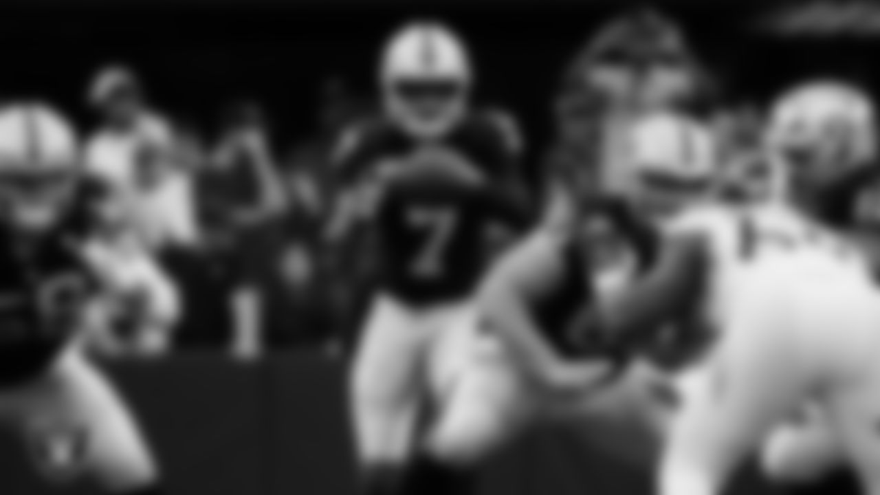 Las Vegas Raiders quarterback Geno Smith (7) receives the snap during the regular season home game against the Tennessee Titans at Allegiant Stadium.