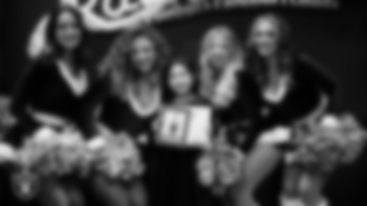 Raiderettes pose for a photo with a Junior Raiderette during the Junior Raiderettes Banquet at The Studio.