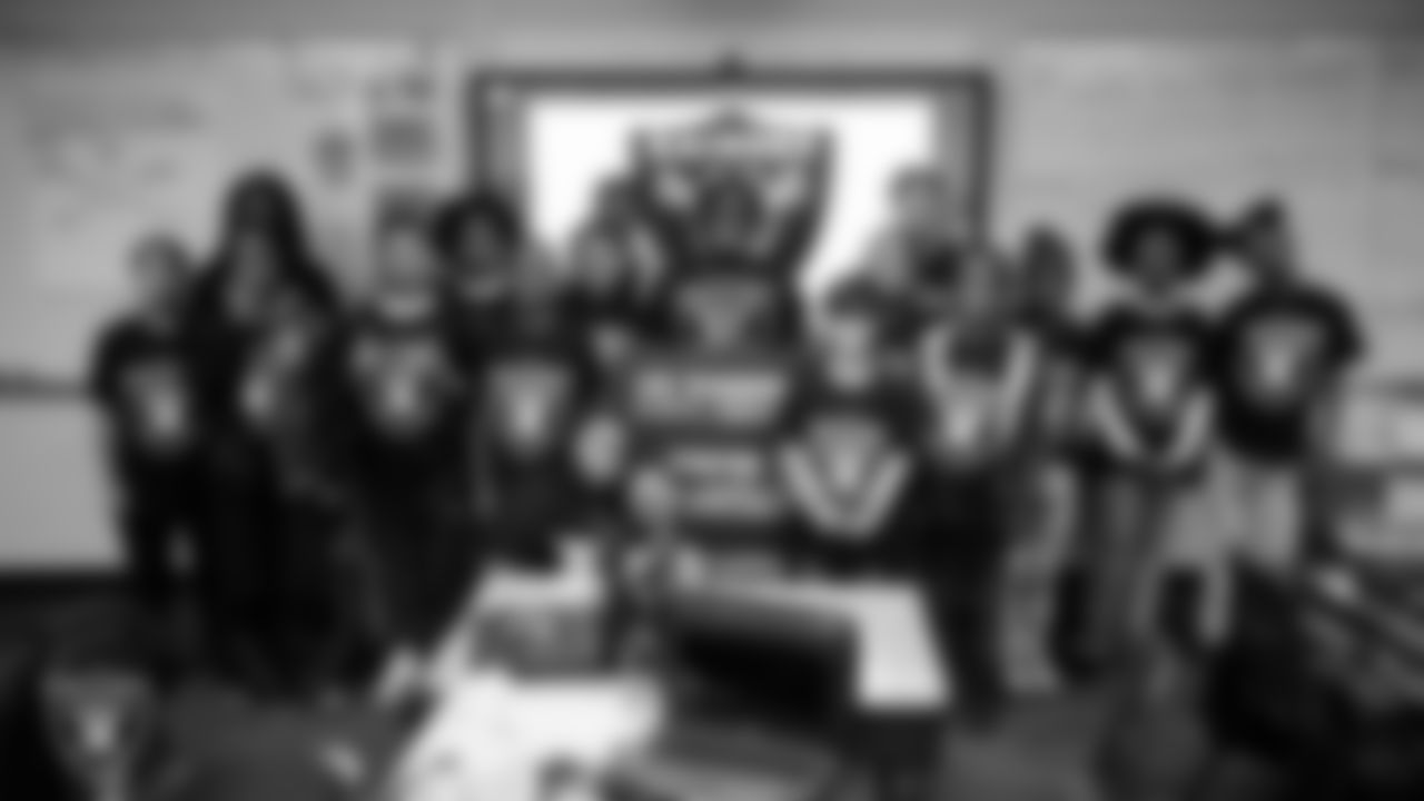 A class celebrates winning the Lil' Raiders School Challenge at Matt Kelly Elementary School.