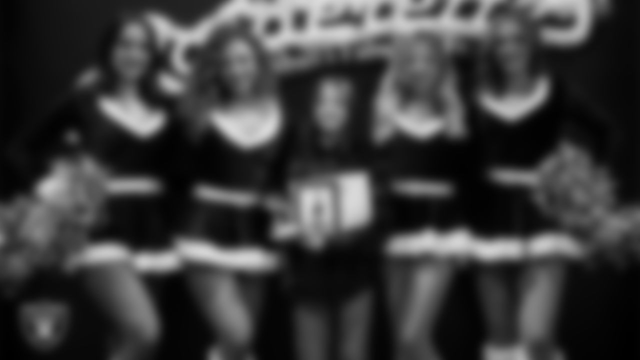 Raiderettes pose for a photo with a Junior Raiderette during the Junior Raiderettes Banquet at The Studio.