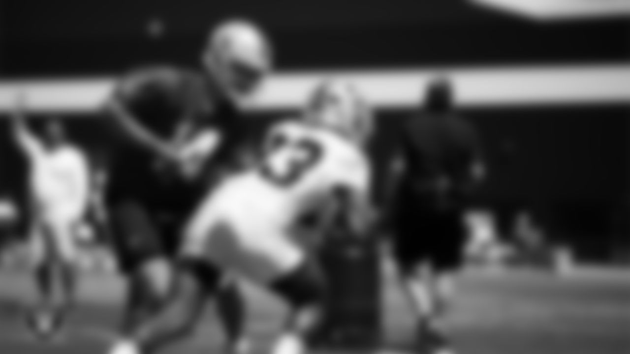 Las Vegas Raiders quarterback Carter Bradley (14) and running back Chris Collier (33) at an Organized Team Activity (OTA) at Intermountain Health Performance Center.