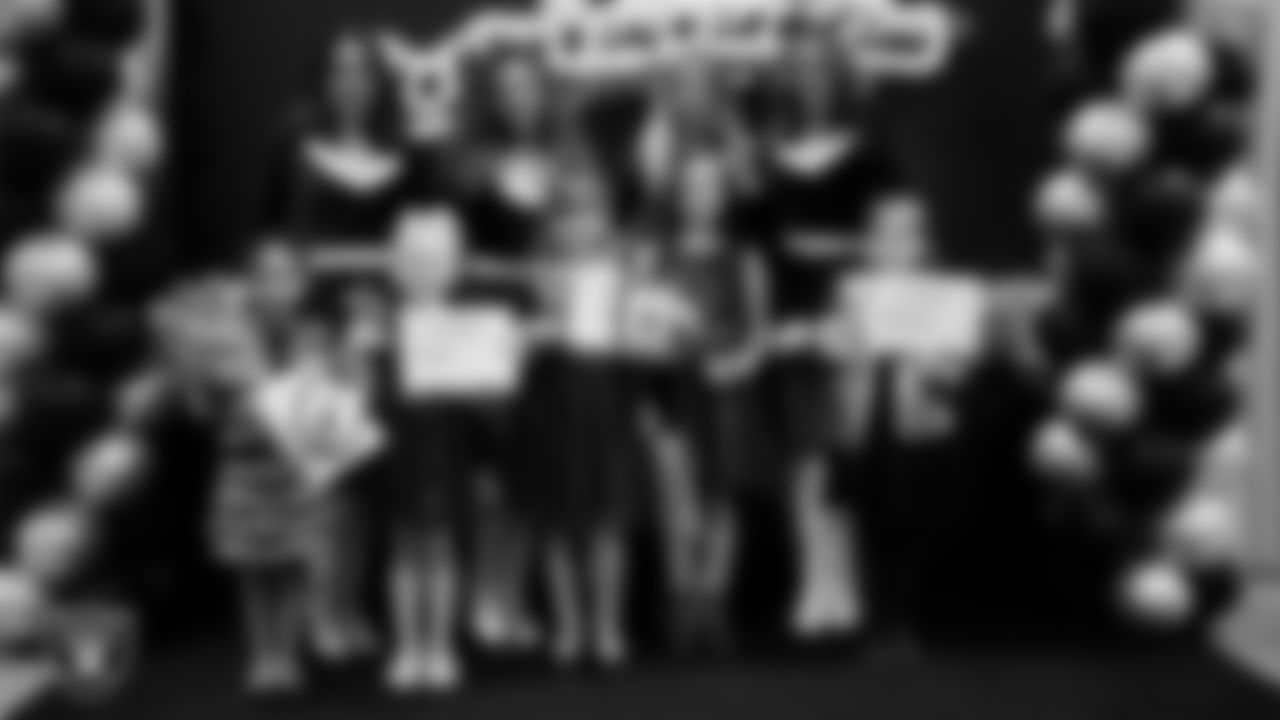 Raiderettes pose for a photo with Junior Raiderettes during the Junior Raiderettes Banquet at The Studio.