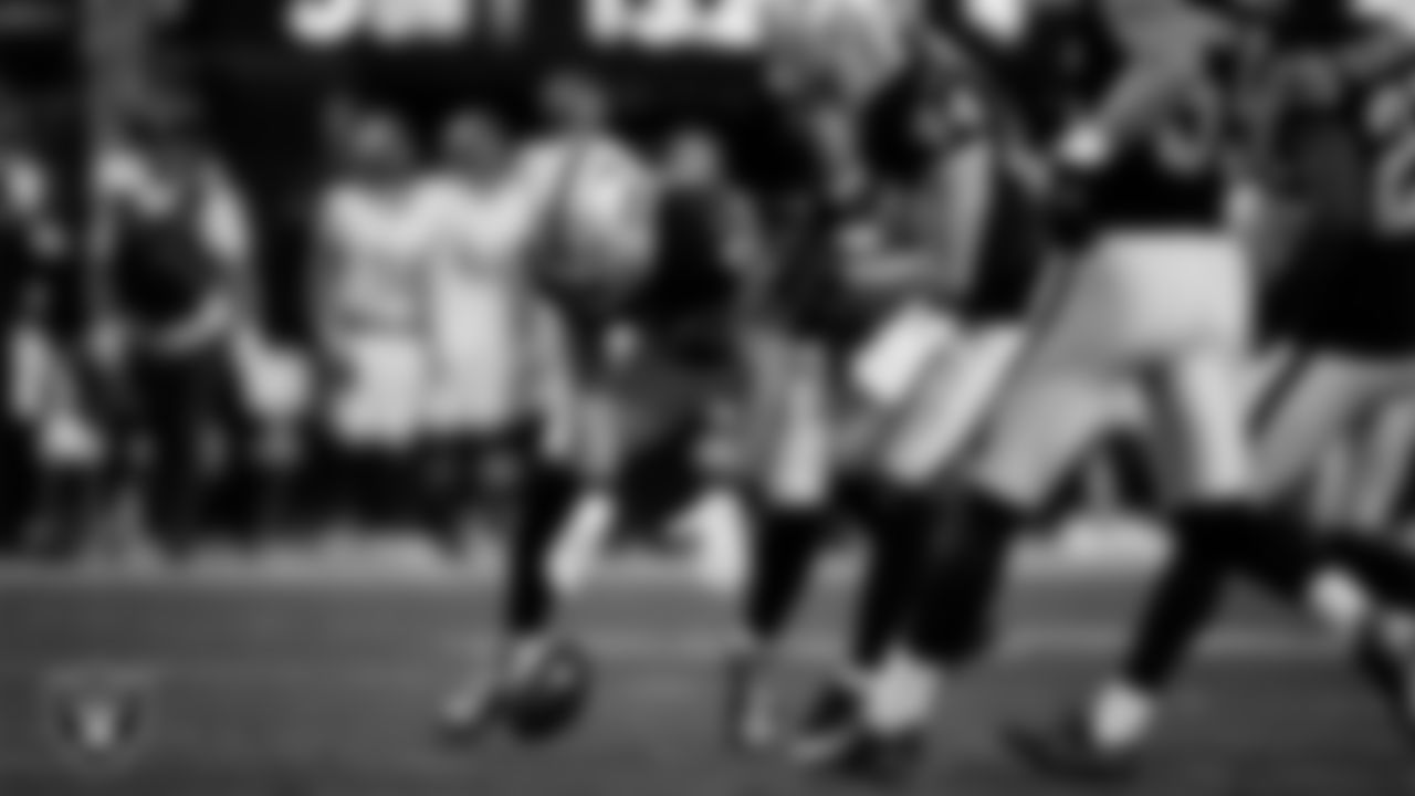 Las Vegas Raiders linebacker Jon Rhattigan (59) downs a punt during the regular season home game against the Denver Broncos at Allegiant Stadium.