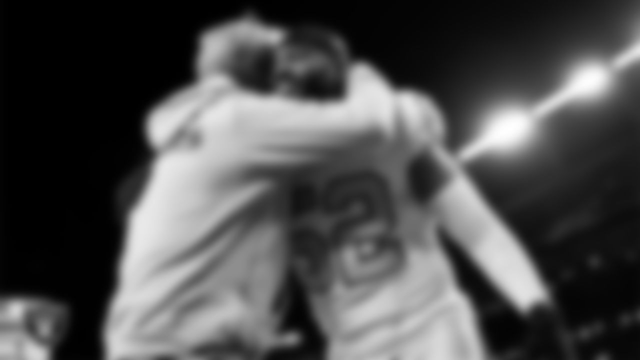 Las Vegas Raiders Head Coach Pete Carroll and linebacker Elandon Roberts (52) before the regular season away game against the Denver Broncos at Empower Field at Mile High.