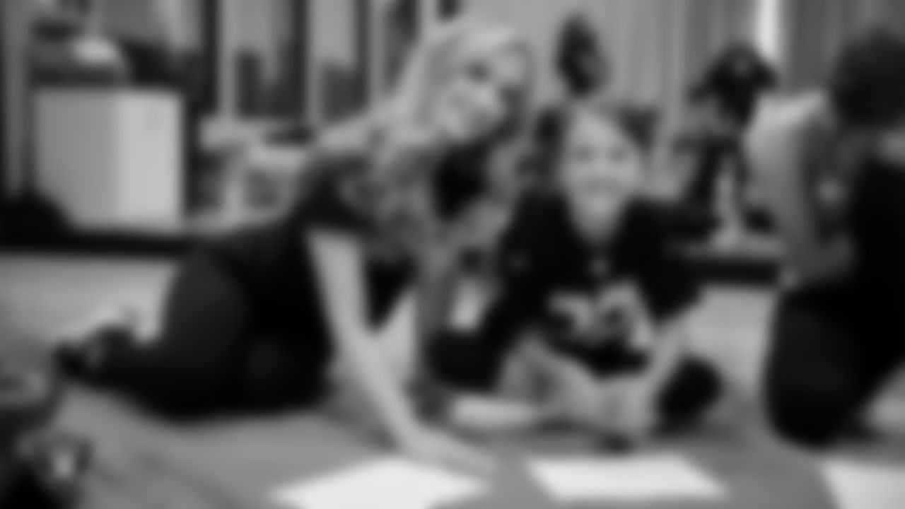 Raiderette Taylor poses for a photo with a dancer during day one of summer camp at The Studio.