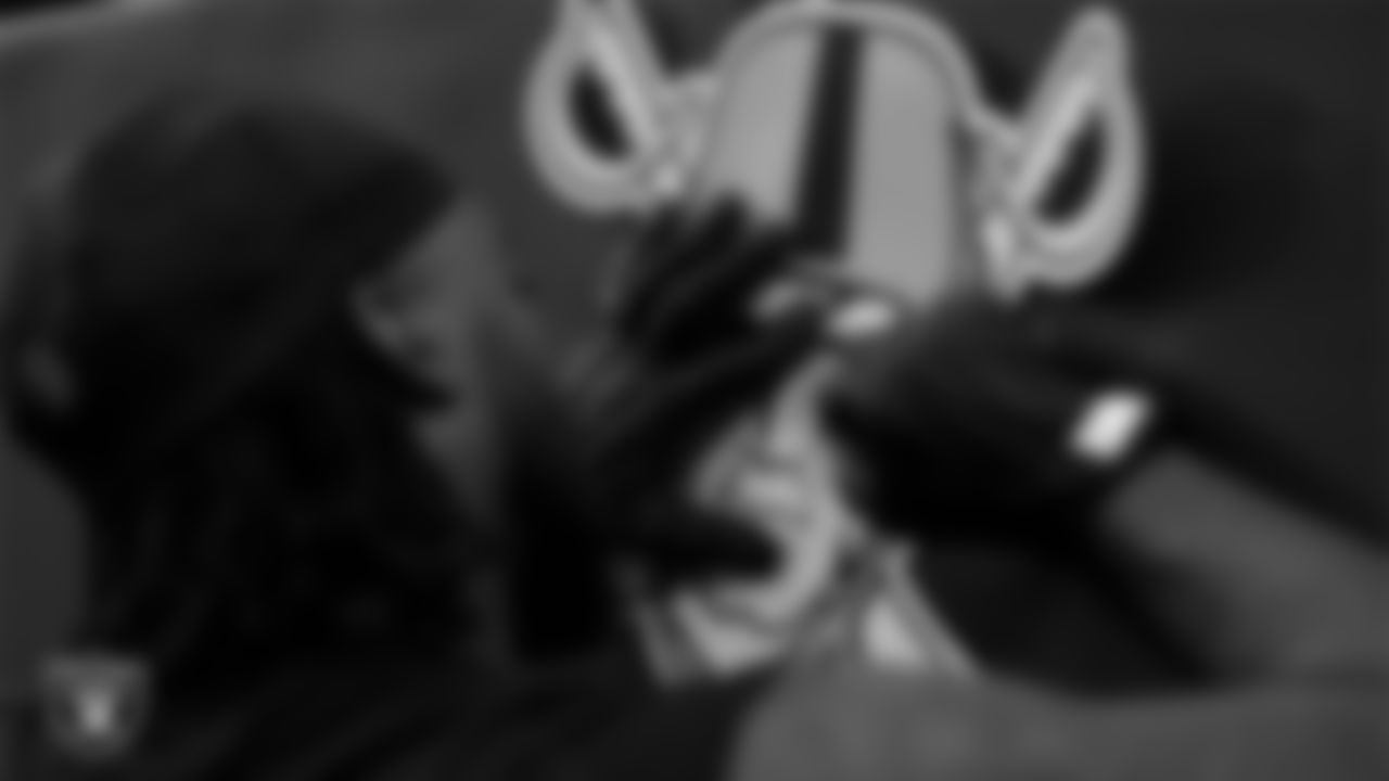 Las Vegas Raiders defensive tackle Adam Butler (69) signs autographs for fans before the regular season home game against the New York Giants at Allegiant Stadium.