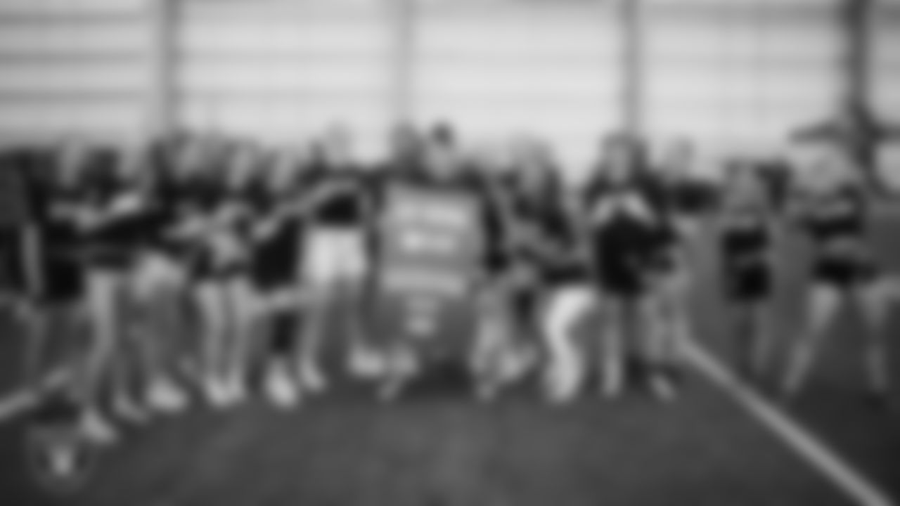 The winner of the Strongest Woman competition poses for a photo with teammates during a Nike 11-On event at Intermountain Health Performance Center.