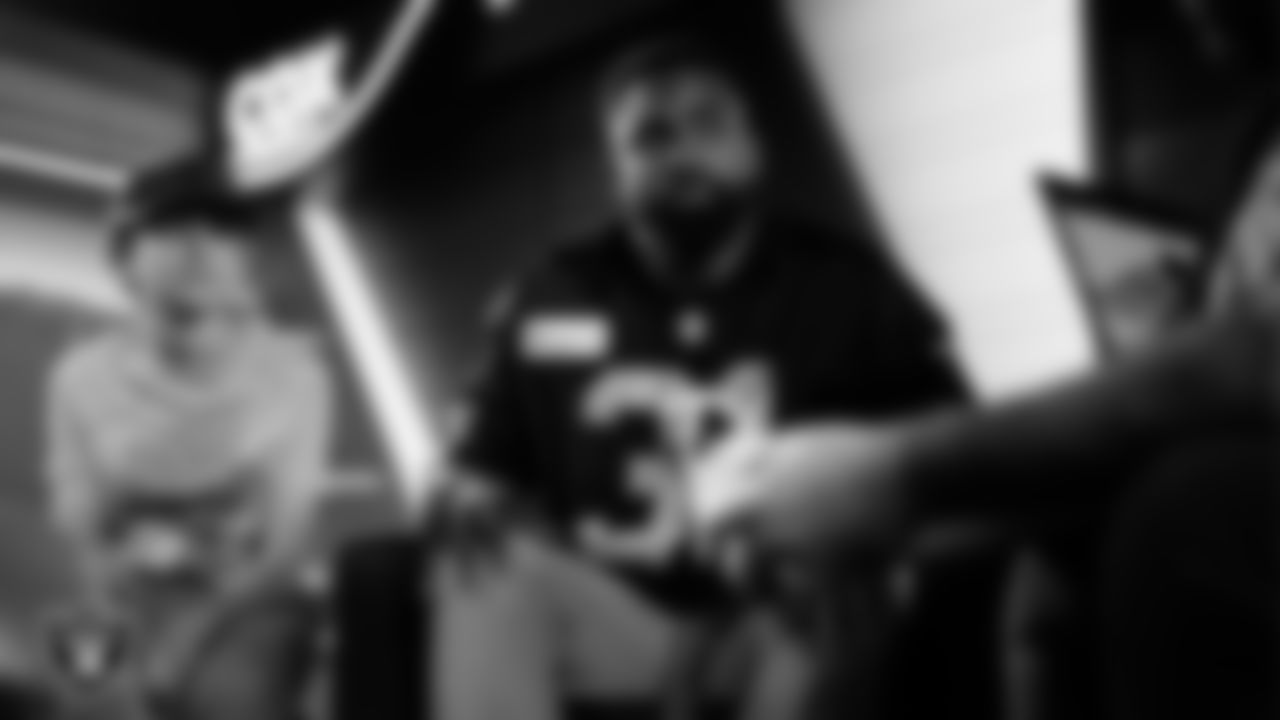 Las Vegas Raiders running back Raheem Mostert (31) works with representatives from Candlelighters Childhood Cancer Foundation and designers to design cleats for My Cause My Cleats in Cox Studios at Intermountain Health Performance Center.