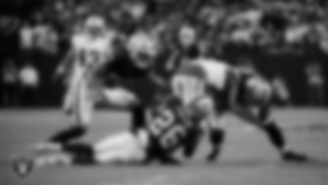 Las Vegas Raiders cornerback Darien Porter (26) and long snapper Jacob Bobenmoyer (50) make a tackle during the regular season home game against the Dallas Cowboys at Allegiant Stadium.