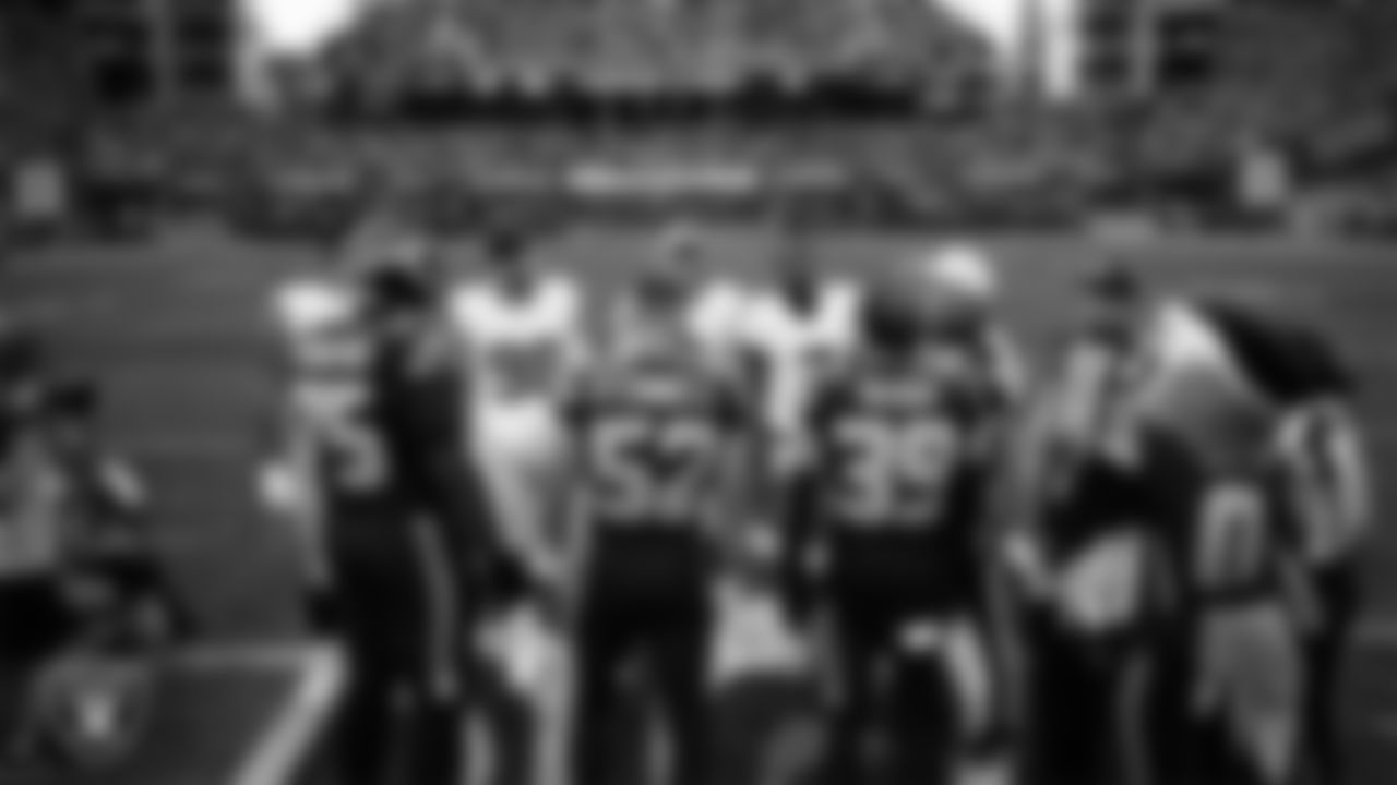 Las Vegas Raiders offensive lineman Laki Tasi (79), defensive end Maxx Crosby (98), punter AJ Cole (6) and quarterback Geno Smith (7) during the coin toss before the preseason away game against the Seattle Seahawks at Lumen Field.