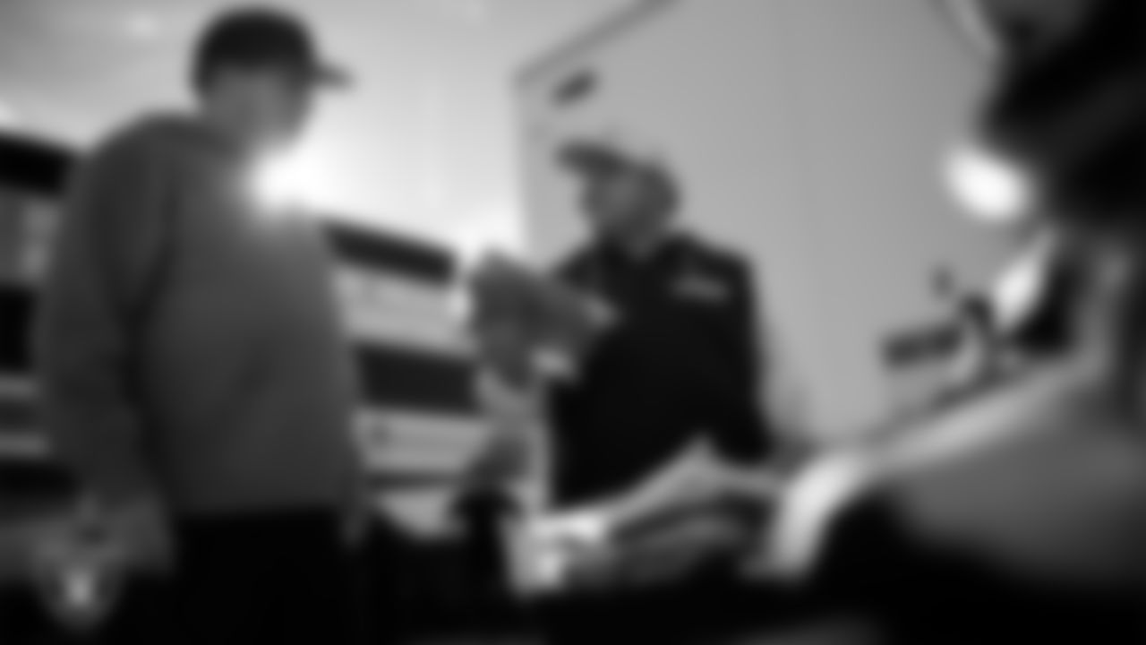 Las Vegas Raiders senior manager of football development Jordan Aguilar hands out equipment to a coach during the Raiders' Equipment Blitz at Intermountain Health Performance Center.