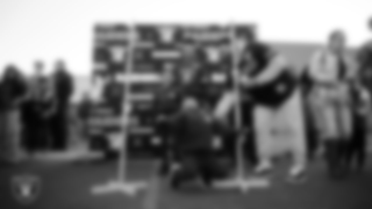 A child plays limbo during the Raiders Holiday Salute at Nellis Air Force Base - Coral Academy.