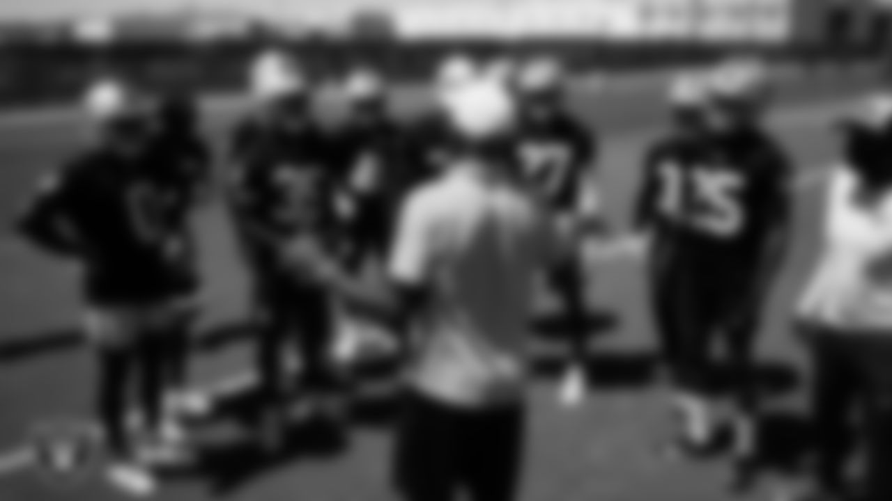 Las Vegas Raiders alumnus Mike Haynes speaks to the defensive backs on the field for mandatory minicamp at Intermountain Health Performance Center.