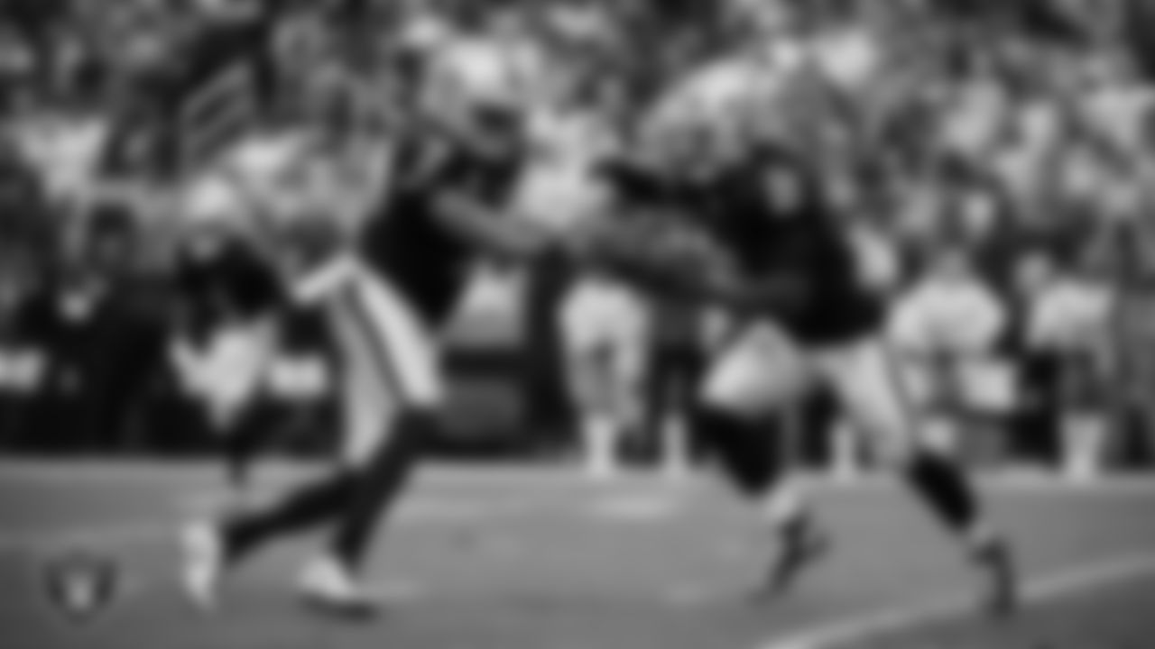 Las Vegas Raiders quarterback Geno Smith (7) hands the ball off to running back Ashton Jeanty (2) during the regular season home game against the Denver Broncos at Allegiant Stadium.