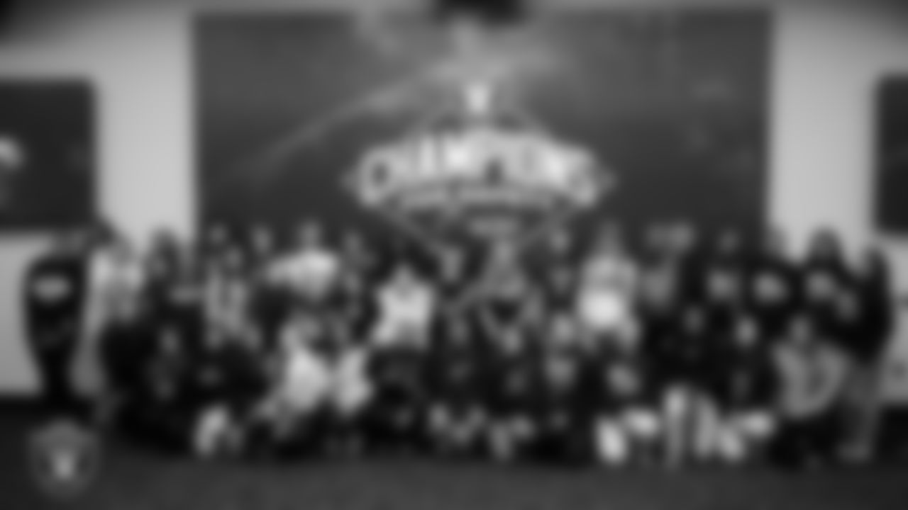 Las Vegas Raiders safety Jeremy Chinn (11) of the Ellie Naqvi from Naqvi Injury Law pose with athletes from Chaparral High School and Clark High School at Intermountain Health Performance Center.