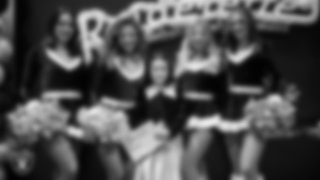 Raiderettes pose for a photo with a Junior Raiderette during the Junior Raiderettes Banquet at The Studio.