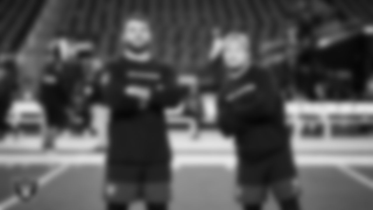 Las Vegas Raiders linebacker Jon Rhattigan (59) and running back Dylan Laube (23) warming up before the regular season home game against the Dallas Cowboys at Allegiant Stadium.