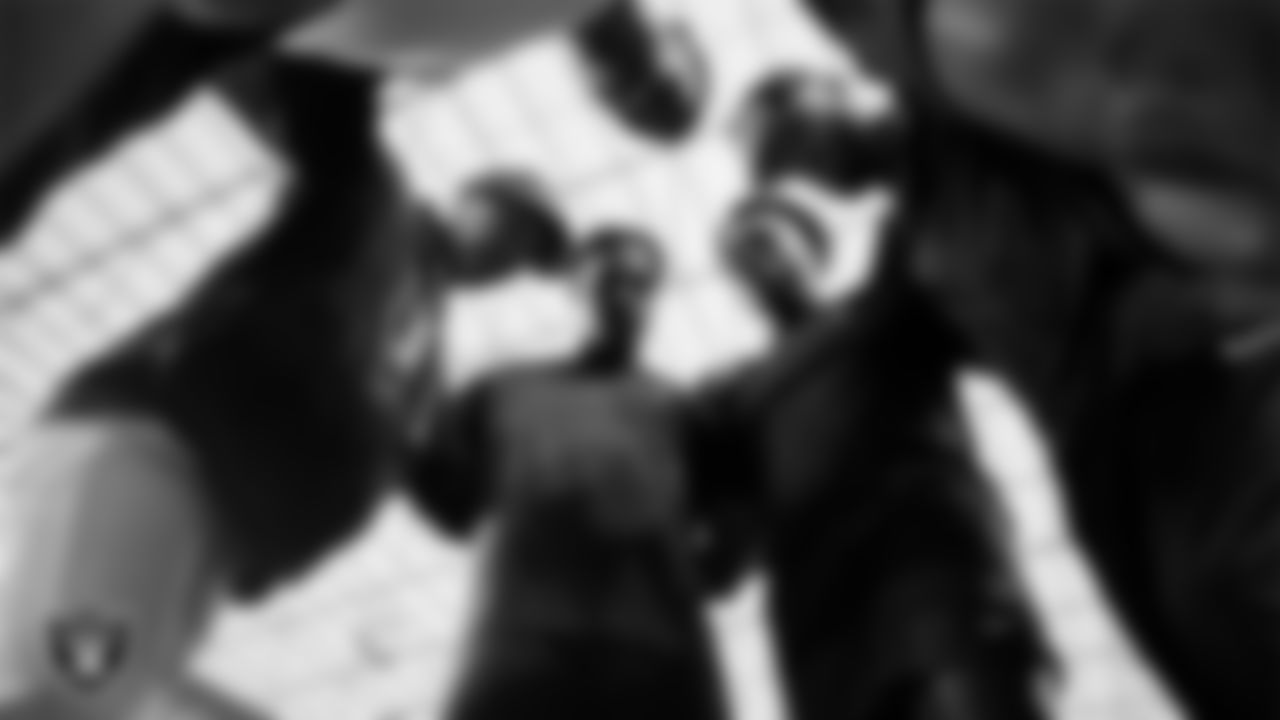 Las Vegas Raiders run game coordinator/defensive line coach Rob Leonard and the defensive linemen huddle before the regular season home game against the Kansas City Chiefs at Allegiant Stadium.