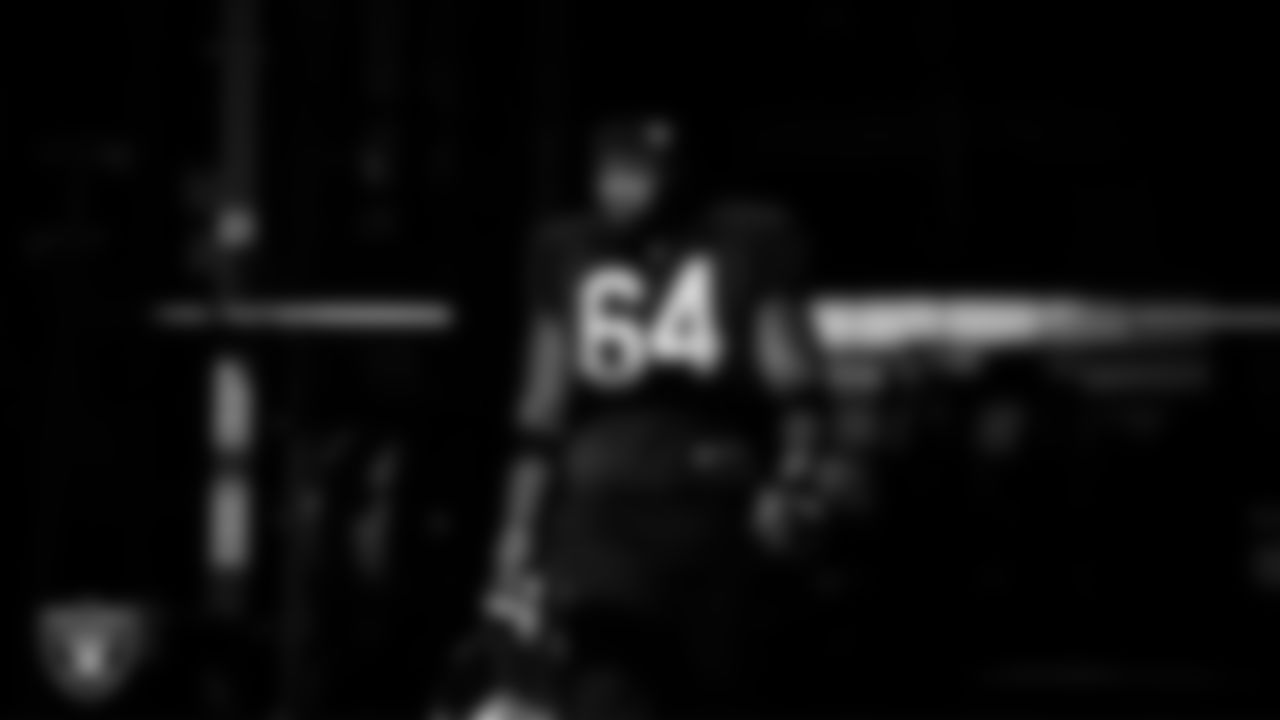 Las Vegas Raiders guard Layden Robinson (64) walks out to the field for practice at Intermountain Health Performance Center.