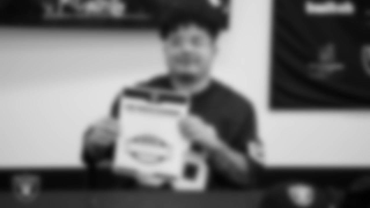 Marcos Carrillo from Make-A-Wish shows off his honorary Raider contract in the Ubeo press conference room during a visit to Intermountain Health Performance Center.