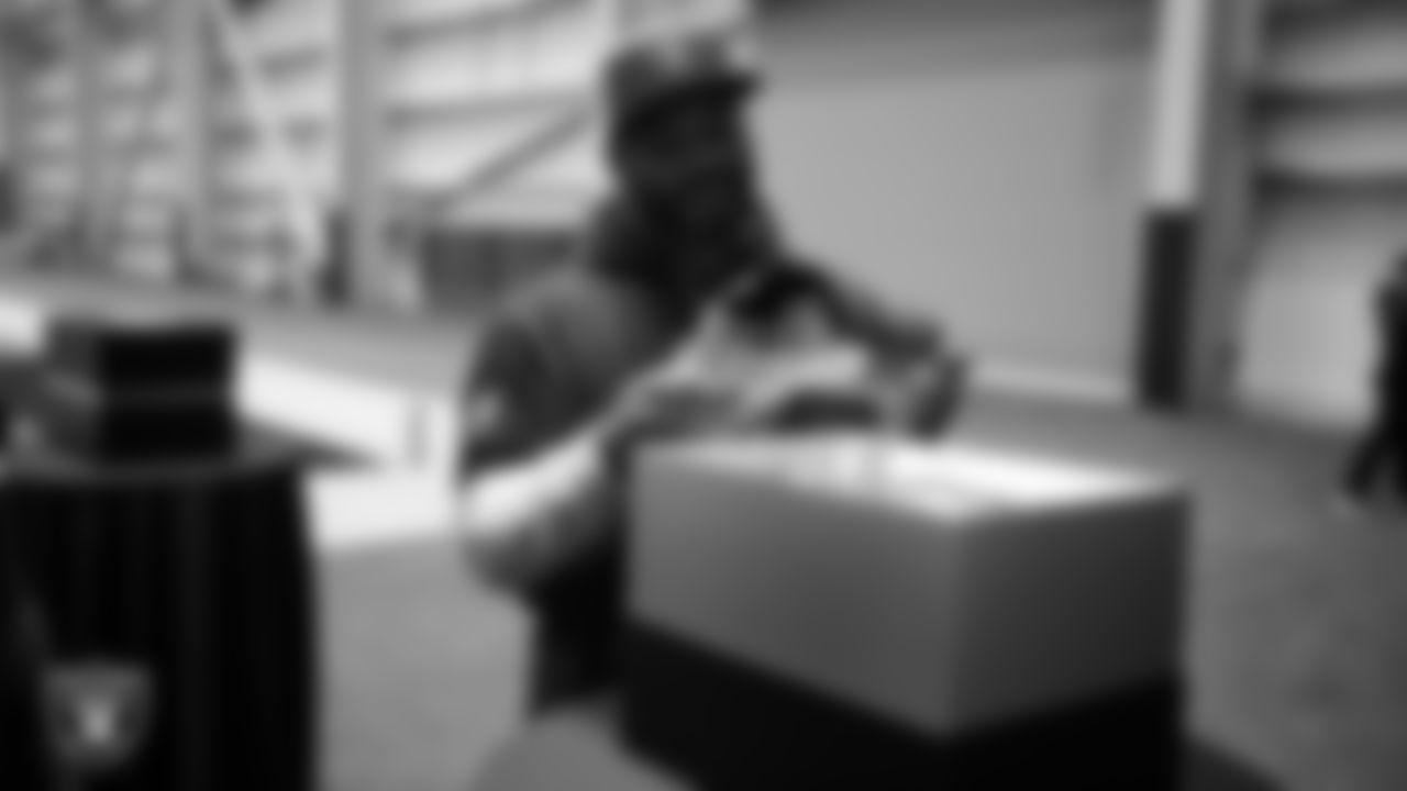 Las Vegas Raiders linebacker Elandon Roberts (52) unboxes his custom cleats for the NFL's My Cause My Cleats initiative at Intermountain Health Performance Center.