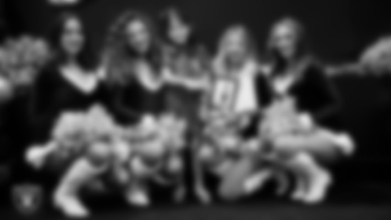 Raiderettes pose for a photo with a Junior Raiderette during the Junior Raiderettes Banquet at The Studio.