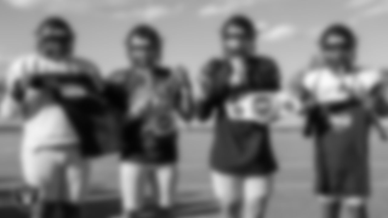 Members of the Desert Oasis High School football team pose for a photo during practice at Desert Oasis High School.