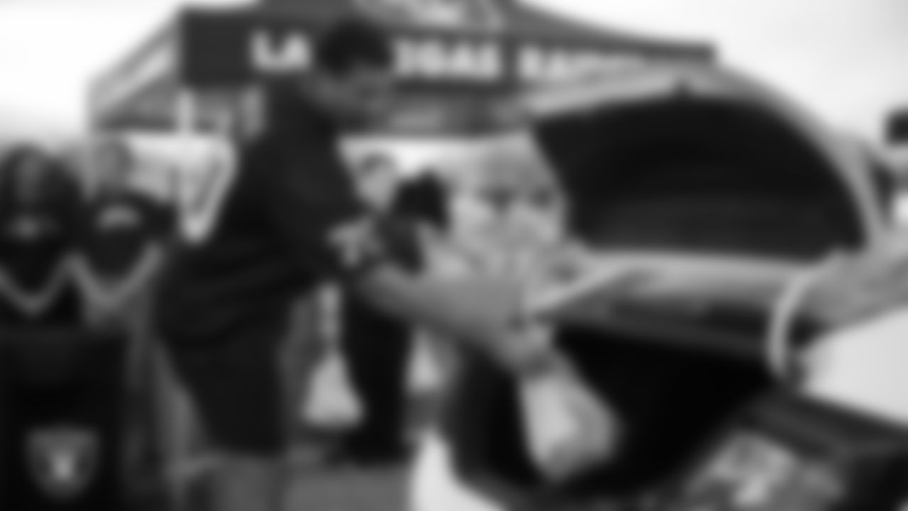 Las Vegas Raiders offensive lineman Stone Forsythe (70) helps distribute Thanksgiving meals to families during Turkey Time with the O-Line at Allegiant Stadium.