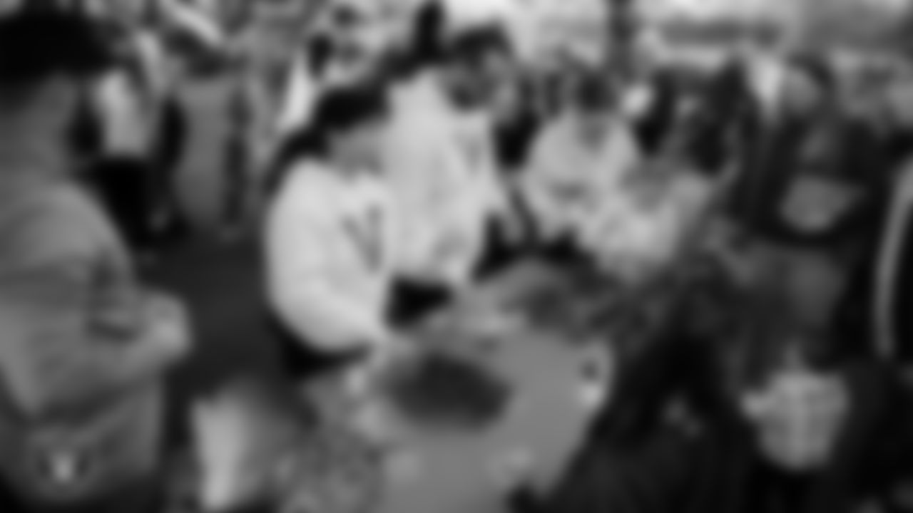 Children decorate ornaments during the Raiders Holiday Salute at Nellis Air Force Base - Coral Academy.