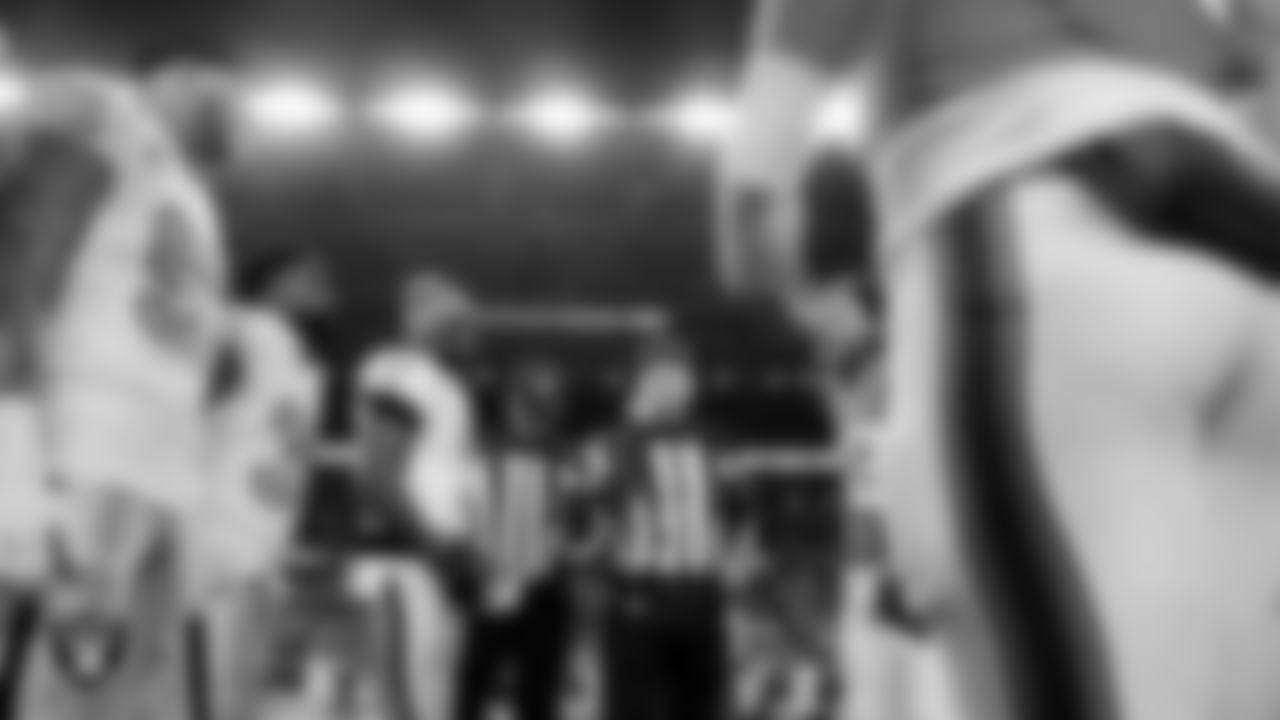 The Las Vegas Raiders during the coin toss before the regular season away game against the Denver Broncos at Empower Field at Mile High.