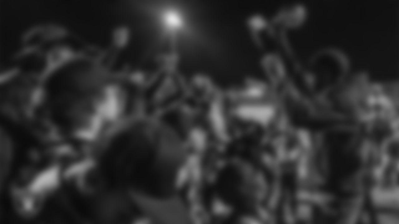 Athletes and coaches celebrate after the City of Las Vegas Silver and Black Youth Flag Football League championship game at All American Park.