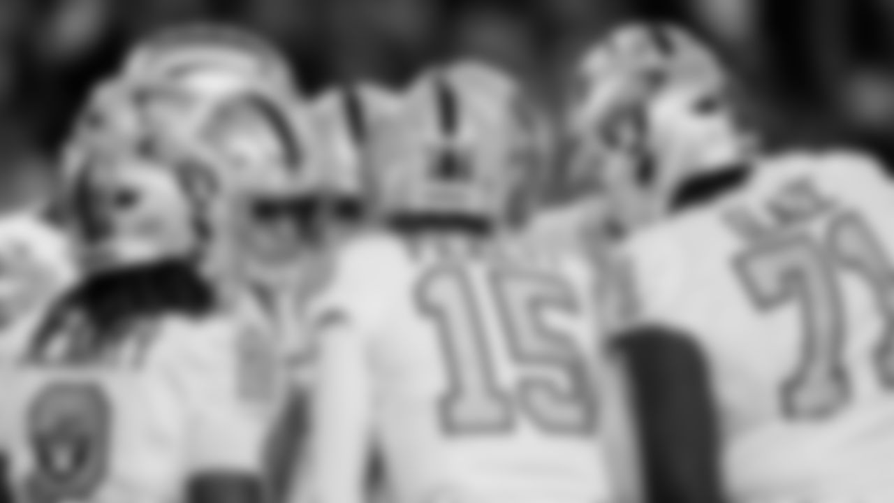 The Las Vegas Raiders offense huddles during the regular season away game against the Denver Broncos at Empower Field at Mile High.