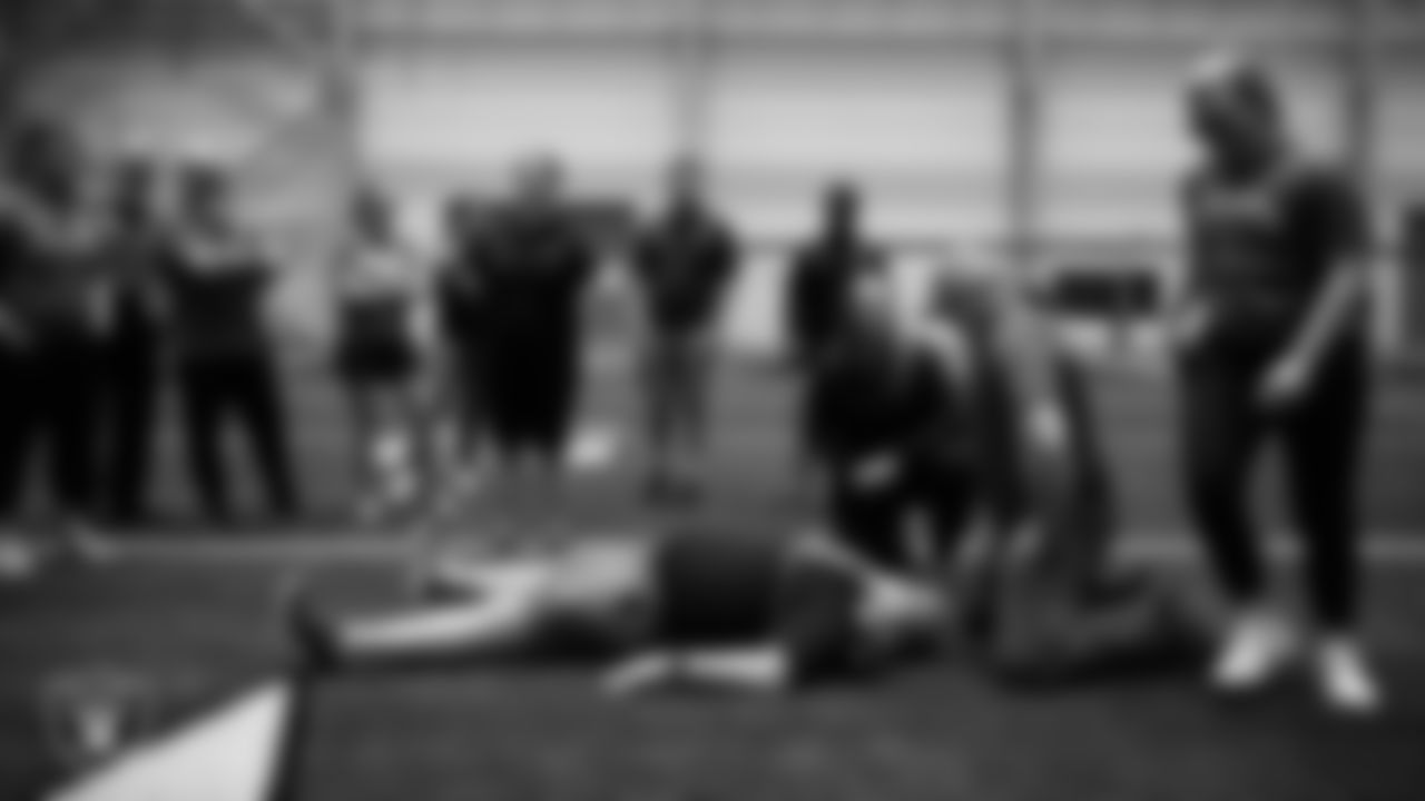 Athletic trainers and coaches work through an emergency care simulation during the Pro Football Cares Sports Emergency Response Training at Intermountain Health Performance Center.