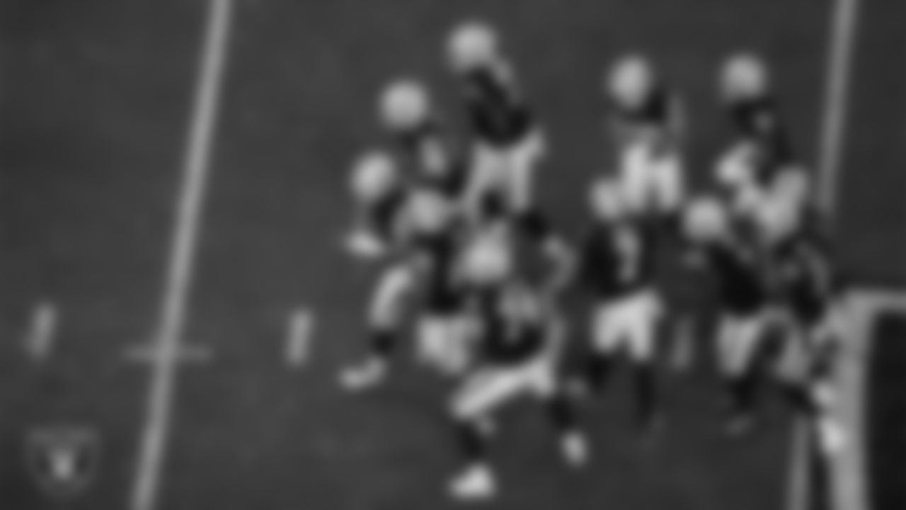 The Las Vegas Raiders offense breaks a huddle during the regular season home game against the Los Angeles Chargers at Allegiant Stadium.