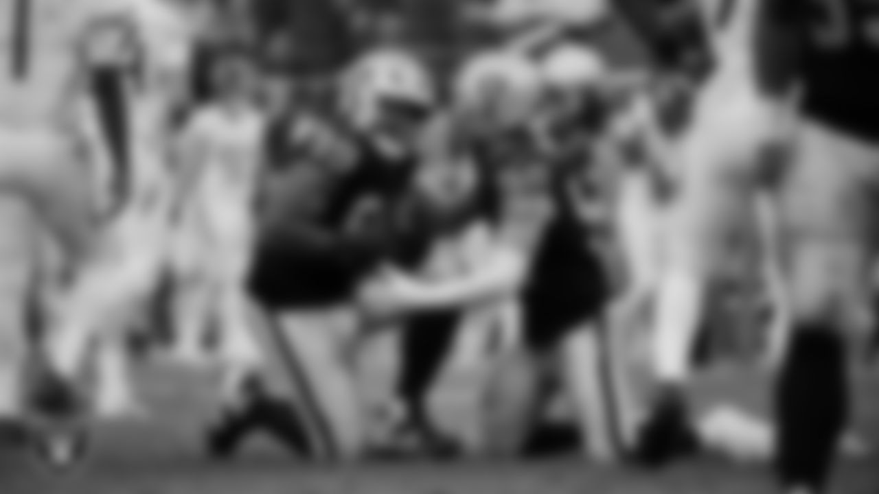 Las Vegas Raiders defensive tackle Thomas Booker IV (99) celebrates with defensive end Maxx Crosby (98) after recovering a fumble during the regular season home game against the Tennessee Titans at Allegiant Stadium.