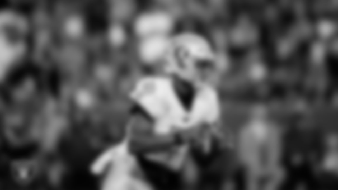 Las Vegas Raiders quarterback Geno Smith (7) looks for a receiver during the regular season away game against the Denver Broncos at Empower Field at Mile High.