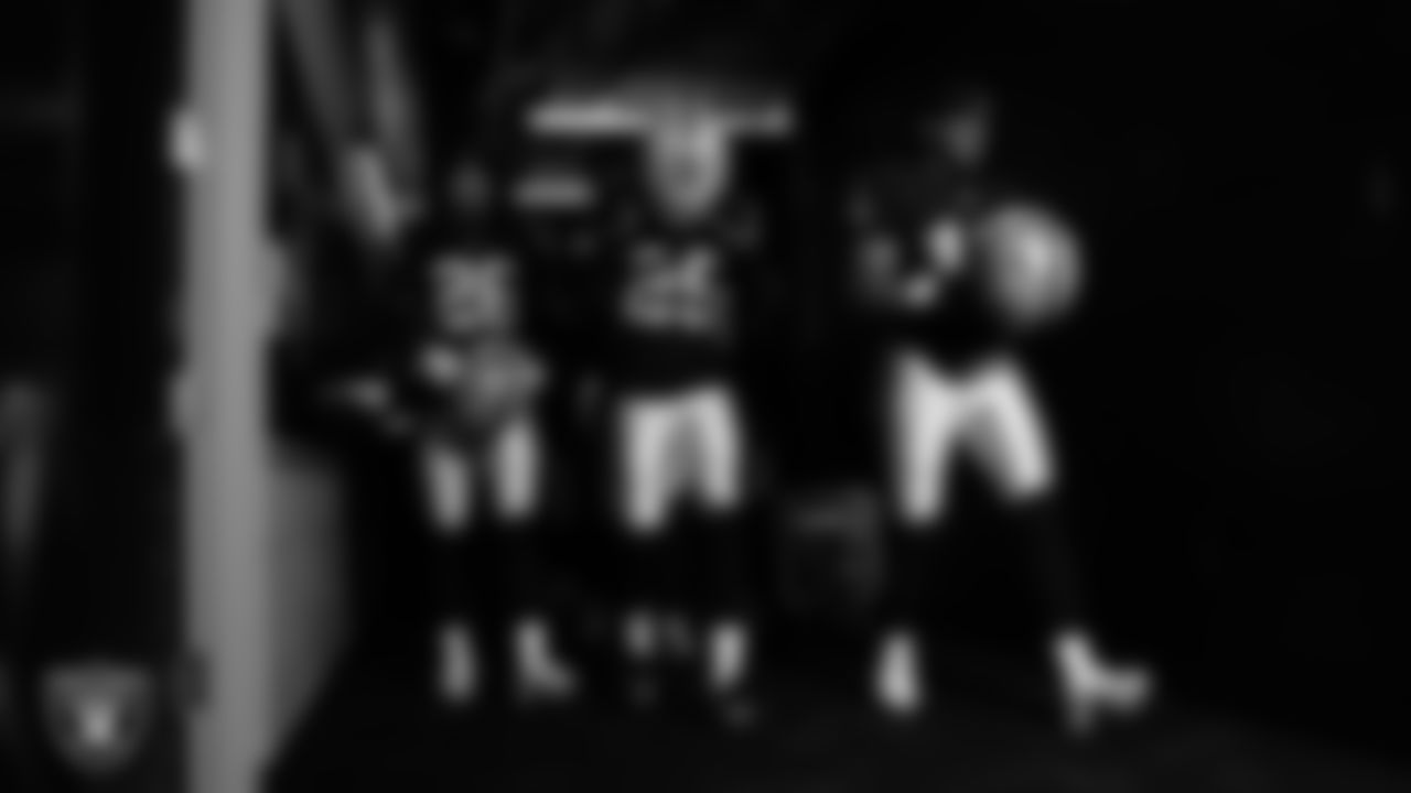 Las Vegas Raiders cornerback Darien Porter (26), cornerback Decamerion Richardson (25) and safety Jeremy Chinn (11) walk down the tunnel before the regular season home game against the Tennessee Titans at Allegiant Stadium.