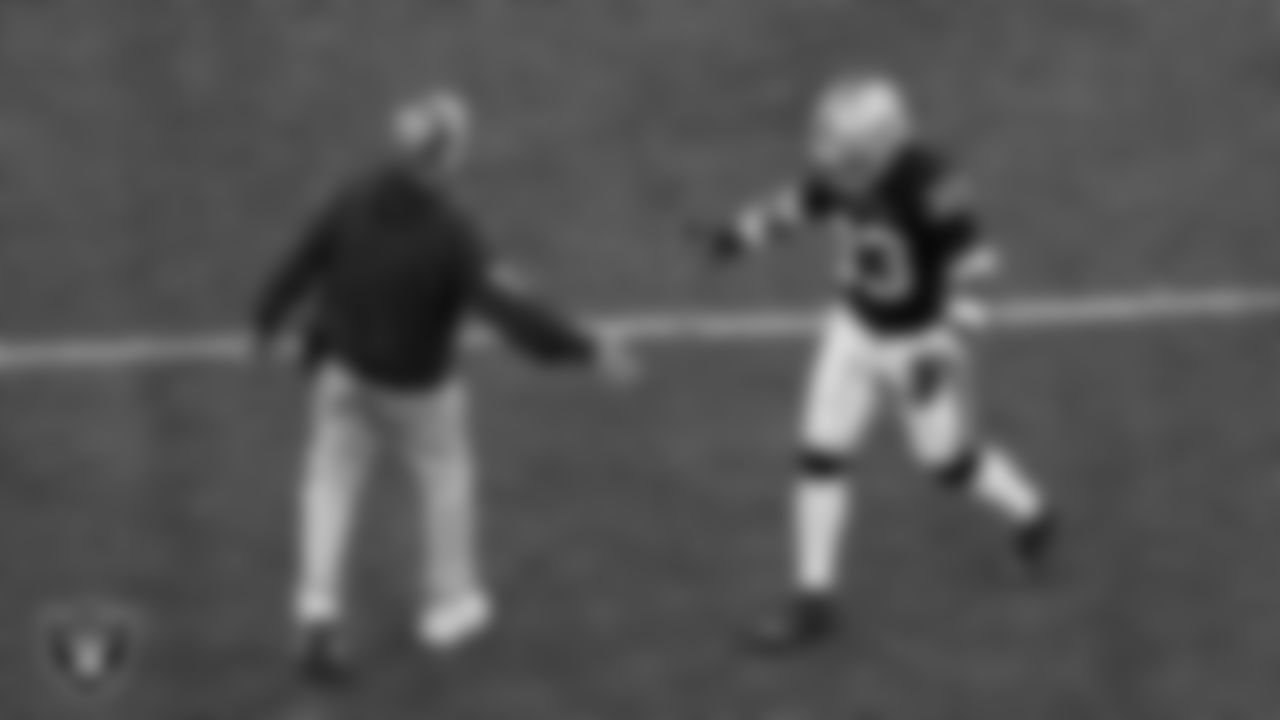 Las Vegas Raiders Head Coach Pete Carroll and linebacker Jamal Adams (33) high-five on the field during the regular season home game against the Dallas Cowboys at Allegiant Stadium.