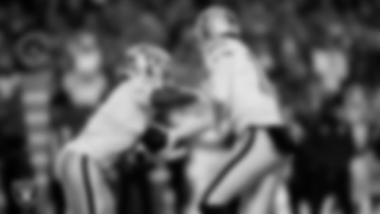 Las Vegas Raiders quarterback Kenny Pickett (15) hands the ball off to running back Ashton Jeanty (2) during the regular season away game against the Denver Broncos at Empower Field at Mile High.