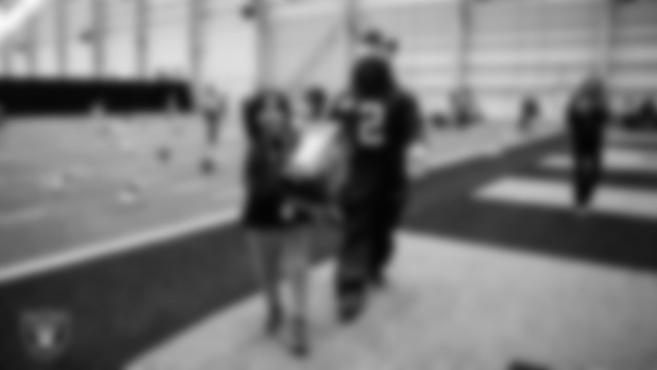 Las Vegas Raiders running back Ashton Jeanty (2) helps a student select toys during a Raiders Youth Holiday Party at Intermountain Health Performance Center.