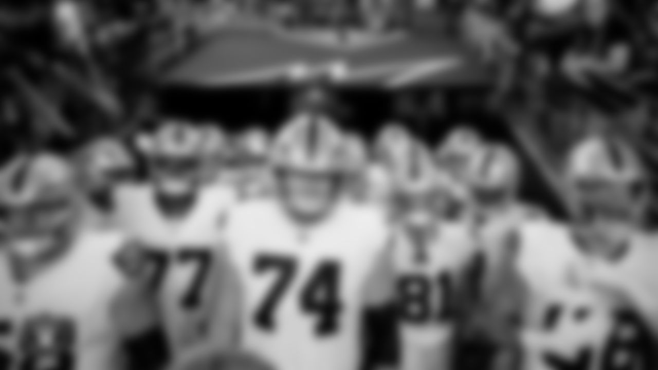 The Las Vegas Raiders wait to be introduced onto the field before the preseason away game against the Arizona Cardinals at State Farm Stadium.