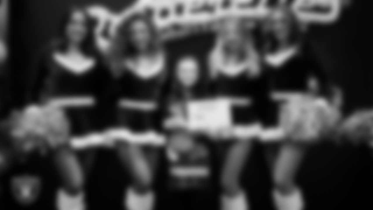 Raiderettes pose for a photo with a Junior Raiderette during the Junior Raiderettes Banquet at The Studio.