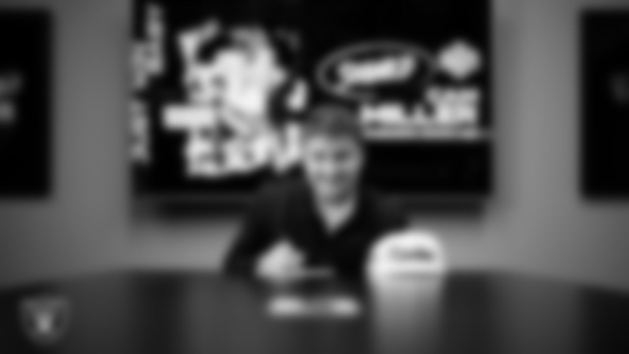 Rookie quarterback Cam Miller signs a contract with the Las Vegas Raiders at Las Vegas Raiders Headquarters.