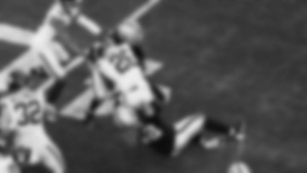 Las Vegas Raiders cornerback Eric Stokes (22) and linebacker Elandon Roberts (52) make a tackle during the regular season home game against the New York Giants at Allegiant Stadium.