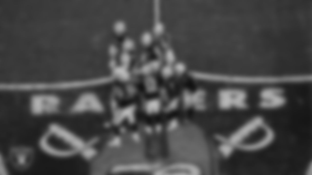 The Las Vegas Raiders offense huddles during the regular season home game against the Kansas City Chiefs at Allegiant Stadium.