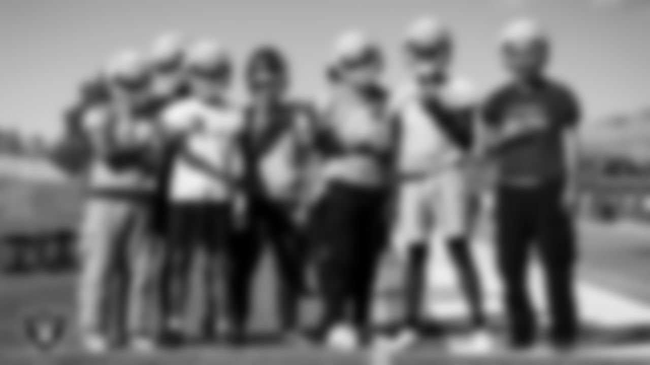 Centennial High School football team members pose for a photo during practice at Centennial High School.