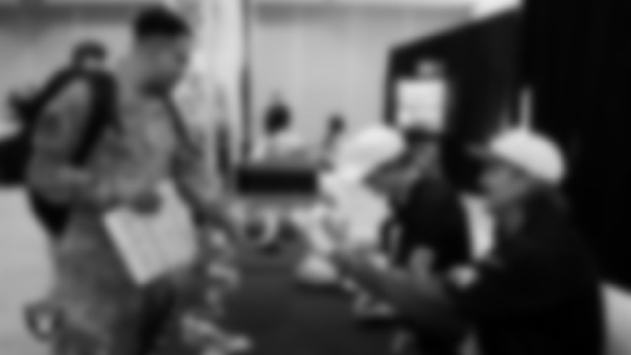 Las Vegas Raiders kicker Daniel Carlson (8) and punter AJ Cole (6) sign autographs for a service member at Nellis Air Force Base.