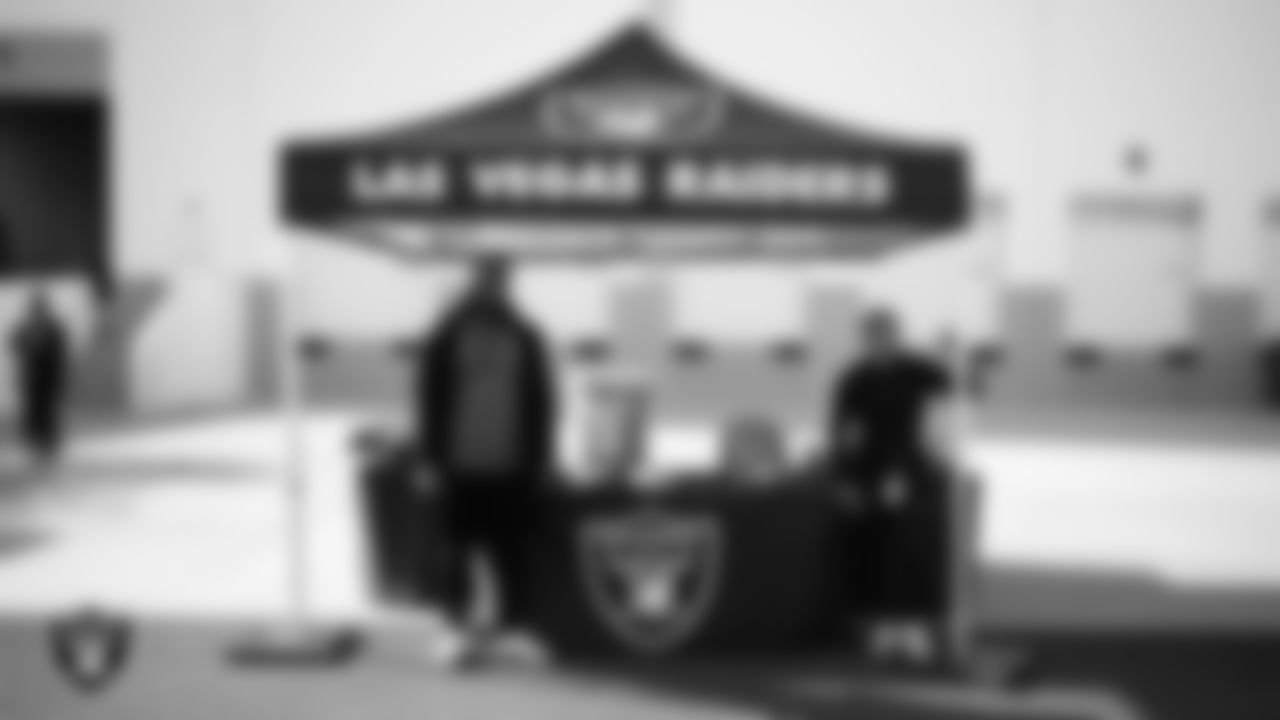Las Vegas Raiders manager of football development Marli Bartlett poses for a photo with Chaparral High School flag football coach Derrick Smith during the football development equipment giveaway at Las Vegas Raiders Headquarters.